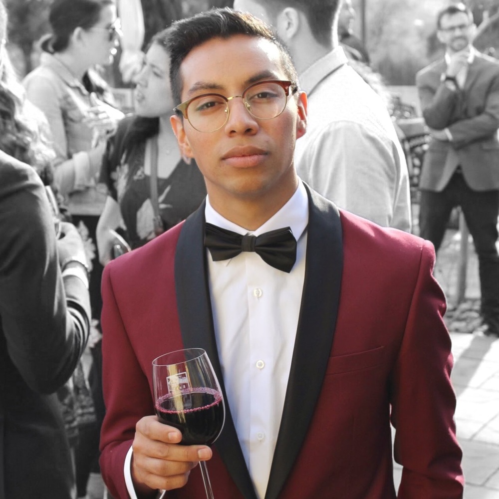 A S/M sized burgundy blazer w/ a black lapels.